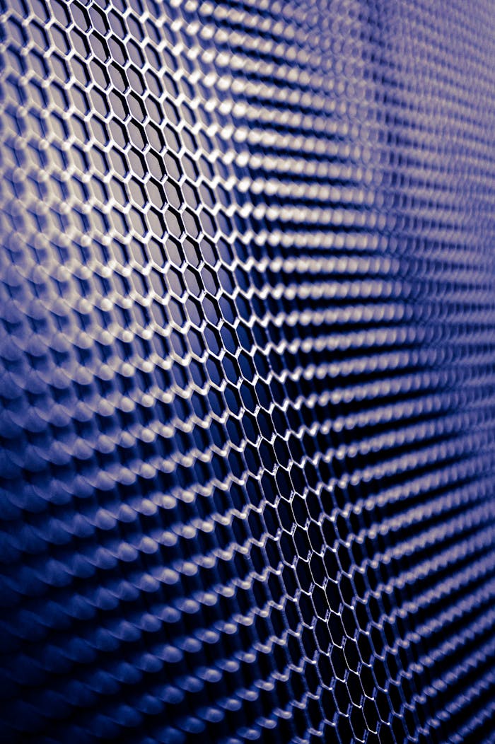 services-02 Close-up of a futuristic metallic hexagonal pattern, perfect for tech designs.